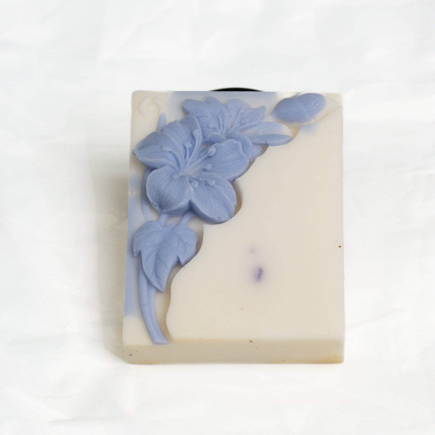 Bar of soap with blue floral design on a white background